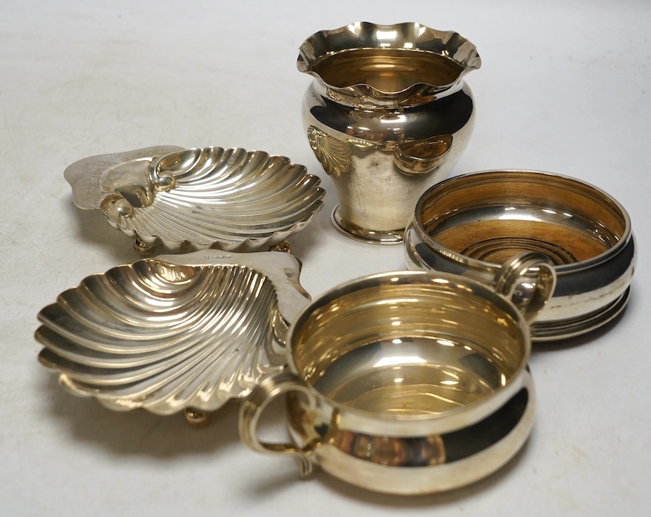 Sundry small silver including a pair of Edwardian butter shells, a vase, a later two handled shallow bowl and a modern wine coaster, 10.9oz. Condition - fair